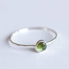 Tiny skinny stackable ring with beautiful moss green tourmaline stone. It is made with a skinny but sturdy band, which allows you creating mind-blowing stacking sets! The ring is ideal for everyday wear and it will also look amazing with a festive dress.The ring is 0,8-0,9 mm thick and looks very dainty on the finger. Choose the size of the stone (3 or 5 mm), stone finish (smooth cabochon or rose cut) and material for the ring (sterling silver or 9k gold).If you want to change the ring band desi Green Sterling Silver Stackable Rings For May Birthstone, Everyday Green Stackable Rings With Bezel Setting, Green Minimalist Stackable Rings With Bezel Setting, Minimalist Green Stackable Rings With Bezel Setting, Everyday Green Gemstone Stackable Rings, Minimalist Green Stackable Rings For Everyday, Everyday Green Stackable Rings, Minimalist Everyday Green Stackable Rings, Green Sterling Silver Stackable Emerald Ring