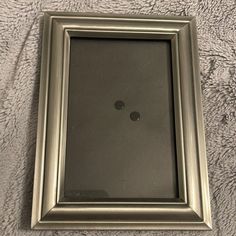 a silver frame with two black dots on it