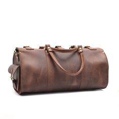 The Weekender Duffle is now available in dark brown and tobacco vintage cowhide leather. This leather has a more rustic finish than our standard veg-tan leather Weekenders. Ready to escape for a few days? Whether it's a weekend road trip or an overseas flight, the Marlondo Leather Weekender Duffle Bag helps you travel in comfort and style. It's easy to pack, easy to carry, and will only look more beautiful with time and use. Its single, spacious compartment will readily house all your travel gea Vintage Brown Leather Backpack For Everyday Carry, Vintage Leather Duffle Bag With Waxed Finish, Brown Waxed Finish Satchel Travel Bag, Classic Brown Vegetable Tanned Leather Bags, Vintage Brown Weekender Bag With Leather Backing, Vintage Leather Duffle Bag With Soft Leather, Vintage Smooth Grain Shoulder Bag For Travel, Brown Waxed Satchel Weekender Bag, Vintage Soft Leather Duffle Bag