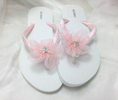 These beautiful flip flops are wrapped in pink satin ribbon, and adorned with an organza ribbon flower with a rhinestone starfish. Ribbon color is pink  if you are needing other colors of ribbon or decoration please contact me and will be happy to accommodate you! All flip flops are handmade to order and the production time 1 to 2 weeks and then please allow additional time for shipping. Amazing for beach, weddings, flower girl or a fancy event, you choose! Please choose your size from the drop Pink Round Toe Flip Flops For Party, Adjustable Pink Sandals For Wedding, Pink Wedding Sandals, Girls Wedding Shoes, Bridal Flip Flops, Girl Sandals, Pink Flip Flops, White Flip Flops, Flower Sandals