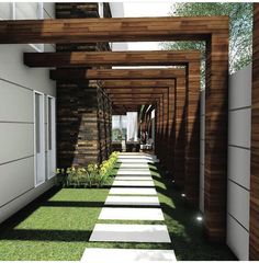 an outdoor walkway is lined with grass and white stepping stones that lead to the front door