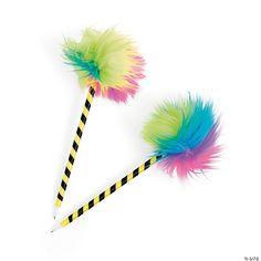 two colorful feathers on top of a black and white striped straw