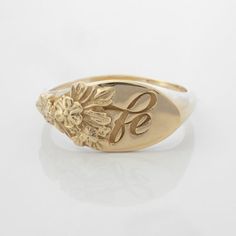 This vintage-inspired floral ring is a row of dainty flowers wrapped around your fingers. Handmade and polished, it is available in solid 8K and 14K gold. This item is engravable with text or monogram of your choice at no extra cost. The initals are engraved onto the ring and embedded in the 3D model for a flawless embossed finish. It is also possible to add a diamond or birthstone or diamond to this ring at an additional fee. Please inquire for details. A few notes about our gold:- Though we do Classic 14k Gold Flower Ring, Elegant Gold Signet Ring With Birth Flower, Delicate Yellow Gold Signet Ring For Wedding, Classic 14k Gold Flower Ring For Anniversary, Dainty Oval Yellow Gold Flower Ring, Elegant Signet Ring With Birth Flower For Anniversary, Gold Signet Ring With Birth Flower For Wedding, Gold Wedding Signet Ring With Birth Flower, Delicate Yellow Gold Engraved Ring For Anniversary