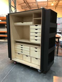 an open cabinet with drawers and shelves in a warehouse