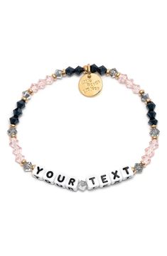 Crystal beads and brassy accents charm this customizable stretch bracelet that lets you add a playful statement of up to 13 characters to your wrist. Customizable with a message of up to 13 characters Glass/acrylic/goldtone plate/textile Imported Latinx Owned/Founded Black Beaded Bracelets With Letter Print As Gift, Black Beaded Bracelet With Letter Print As Gift, Personalized Inspirational Black Bracelets, Inspirational Personalized Black Bracelets, Customized Black Trendy Stretch Bracelet, Adjustable Black Charm Bracelet With Letter Beads, Black Novelty Stretch Bracelet As A Gift, Black Novelty Stretch Bracelet For Gift, Personalized Black Stretch Bracelet For Friendship