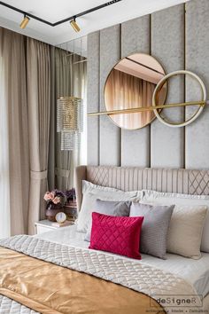 a bedroom with a large bed and round mirror on the wall