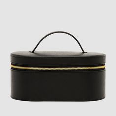 Crafted from our luxurious, textured Recycled Saffiano Leather (outer) and smooth nylon lining (interior), the Essential Vanity Case is a durable, reinforced leather case designed with gold hardware for added elegance. A separate pouch is also included to store your prized possessions, and elastic straps on the lid can securely hold your makeup brushes in place. Dimensions: 11cm (H) x 22cm (W) x 13cm (D) Pictured here: Our "Serif" font in size 24pt, in Gold.SKU code: VANITCSE-RS-BLA-GO-1-WKM Luxury Makeup Bag, Luxury Pouch, The Daily Edited, Caking It Up, Vanity Case, Recycled Leather, Makeup Pouch, Makeup Case, Serif Font