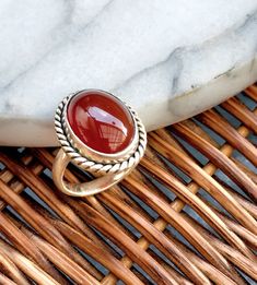 "Carnelian ring,size 8,silver,vintage ring,aqeeq ring,gift,statement ring,jewellery,middle eastern,Persian,big stone, unique Size:8 US Beautiful carnelian ring. Oval shape stone with rope design frame. Solid thick band sets really well on finger. The design of this beautiful ring is inspired by Persian jewellery. ► Giving this as a gift? Don't worry, it comes in beautiful packaging, and ready for gift giving! If you would also like to include a small message, please leave a note during checkout. ► If ordering multiple items, I will automatically package them in the same gift box. If you would like to have them packaged in their own individual gift box, then please leave me a note at checkout in \"note to seller\". -gift wrapping  -great as a gift" Silver Carnelian Ring Jewelry, Bohemian Oval Hallmarked Jewelry, Bohemian Oval Cabochon Ring, Bohemian Rings With Large Stone For Gift, Bohemian Sterling Silver Oval Cabochon Rings, Bohemian Silver Oval Cabochon Ring, Silver Bohemian Oval Cabochon Ring, Bohemian Jewelry Stamped 925 With Oval Cabochon, Bohemian Jewelry With Large Oval Cabochon Stone