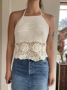 "Hand made crochet halter top in off-white  Slightly cropped  Designed and hand crocheted  Modeled on a size 6 - 34b - 28\" waist  Would best fit a size small-medium  Made from 52% cotton 48% acrylic yarn Garment Measurements  Pit to pit laying flat 16.5\" Front length 14\" Back length 8\"" White Crochet Halter Top For Summer, Fitted Halter Top With Crochet Trim For Spring, Vacation White Crochet Lace Halter Top, Fitted Crochet Trim Halter Neck Top, White Crochet Lace Halter Top For Vacation, Fitted Halter Neck Crochet Top With Crochet Trim, Fitted Halter Neck Tops With Crochet Trim, White Halter Neck Crochet Top For Summer, White Bohemian Halter Top With Crochet Lace