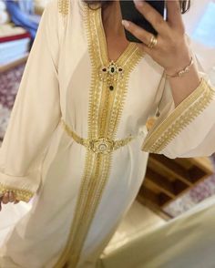 Moroccan Fancy White Dress with golden embroidery, this dress is made to order and can be customized. Floor-length Embroidered Dress For Wedding, White Floor-length Dress With Gold Embroidery, Floor-length Dabka Embroidered Wedding Dress, Gold Embroidered Dress For Eid, Gold Zari Work Long Sleeve Gown, Gold Long Sleeve Gown With Zari Work, White Dress With Gold Embroidery For Eid, White Floor-length Kaftan For Traditional Ceremonies, Elegant Embroidered Dress With Zari Work For Traditional Ceremonies