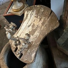 an old wooden rocking chair sitting on top of a pile of other woodworking items