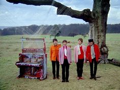 three people standing in front of a trunk with strings hanging from it's sides