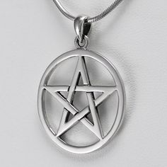 a silver pentagram pendant on a white background