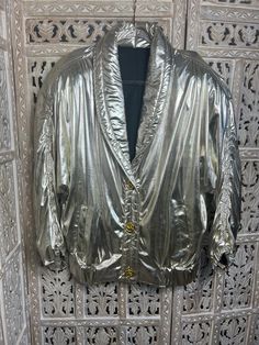 This stylish ladies' vintage casino jacket adds a touch of class to any outfit. It's made from a shiny light gold fabric and features 3 intricately detailed gold buttons. The perfect way to add some dazzle dazzle for a night out or special occasions. Size L/XL Gold Blazer With Gold Buttons For Spring, Gold Party Blazer With Gold Buttons, Glamorous Gold Blazer For Formal Occasions, Glamorous Gold Formal Blazer, Glamorous Gold Long Sleeve Blazer, Gold Formal Winter Outerwear, Glamorous Gold Outerwear For Formal Occasions, Glamorous Gold Formal Outerwear, Gold Long Sleeve Outerwear With Button Closure