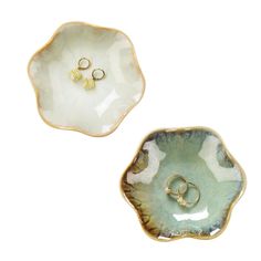 two small dishes with gold rings on them