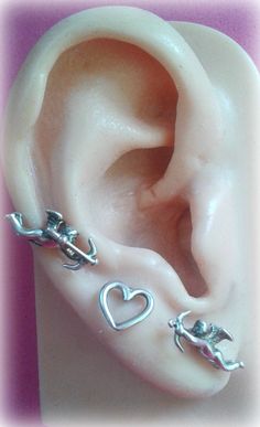 Angel Cupid with bow and arrow earrings. Angel cherub shoots hiw arrow. Angel of love studs made of sterling silver 925*. The design is 3D. Totally handmade♥ Choose between 2 version 1) A pair of Love Angels ( Cupids ) 2) A pair of Cupids and a pair of Hearts. Dimensions: approx. 1 cm -It is shipped as registered mail and in a fine box for you to keep or present it as a gift! - Ready to be shipped within 3 to 5 BUSINESS days. THEN, It is usually needed 3-6 days for Europe and 7-15 days for every Cupid Jewelry, Cupid Earrings, Silver Bow And Arrow, Cupid Aesthetic, Pjo Oc, Cupid Bow, Angel Of Love, Angel Cupid, Dream Accessories