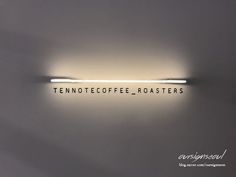 there is a sign that says tennoffe coffee roasters on the wall above it