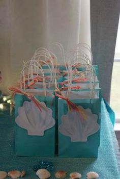 small bags with seashells are sitting on a table