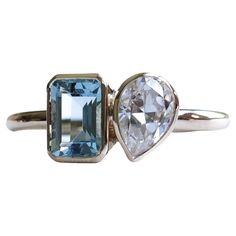 Emerald cut aquamarine with pear moissanite on this you and me ring. Metal: 14k Gold Stone 1: Aquamarine Stone Shape: Emerald cut Stone Size: 5mm x 7mm Stone 2: Moissanite Stone Shape: Pear Stone Size: 5mm x 7mm Color: DEF Forever One Charles and Colvard Band Width: Approx 1.8mm band width This ring is customizable with your choice of gemstones. Please contact us for custom work. Toi Et Moi Aquamarine, Garden Party Wedding, Aquamarine Stone, Gold Stone, Ring Metal, Emerald Cut, Party Wedding, Garden Party, Aquamarine