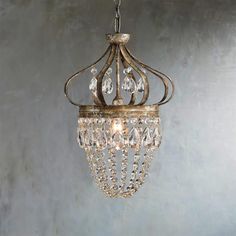 a chandelier hanging from a ceiling with crystal drops on the bottom and sides