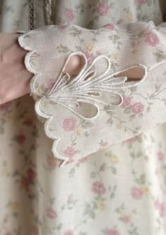 a close up of a person's hand holding an object with flowers on it