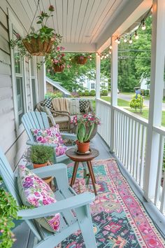 a porch with chairs and rugs on it