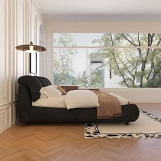 a bed sitting on top of a hard wood floor next to a window with lots of windows