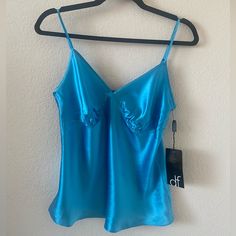 Brand: Daisy Fuentes Size: Small Color: Turquoise Condition: Brand New With Tags Material: 100% Silk Note: Cat Friendly House Blue V-neck Tank Top With Built-in Bra, Blue Spaghetti Strap Camisole For Night Out, Blue V-neck Tank Top For Night Out, Blue Camisole Tank Top For Night Out, Blue Tank Camisole With Built-in Bra, Blue Stretch Camisole, Blue Sleeveless Camisole With Built-in Bra, Blue Tank Camisole For Party, Elegant Blue Tank Camisole