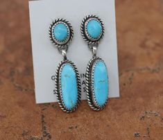 Very Nice, Navajo Native American earrings by Freda Martinez. They are made from sterling silver and turquoise. Each earring is 1 7/8" in length and 1/2" in width. We are proud to offer a wide variety of beautiful Native American Jewelry and Accessories. We carry Navajo, Santo Domingo, and Zuni pieces featuring stones like turquoise, coral, onyx, mother of pearl, and much more. Our jewelry is a perfect addition to your collection. It can be worn as part of your daily wardrobe and on special occa Earrings Native American, Native American Earrings, Turquoise Stud Earrings, American Jewelry, Jewelry And Accessories, Native American Jewelry, Silver Turquoise, Turquoise Sterling Silver, Jewelry Earrings Studs