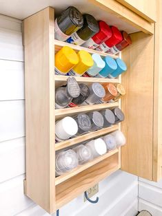 an organized spice rack in the corner of a kitchen