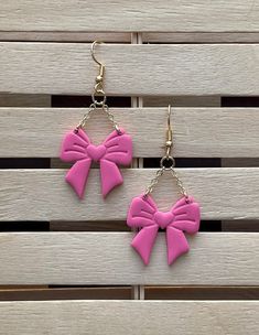 Pink Bow shaped earrings.  Handmade from polymer clay, super lightweight. Measures at 2.25 inches from hook to end. All earrings are made with love! Treat them well, because although they are durable, they are handmade, unique and hard to replace! **No returns or exchanges** If damaged upon delivery please reach out within 2 days of receipt for assistance. Thanks!! Pink Polymer Clay Earrings For Valentine's Day, Pink Resin Novelty Earrings, Pink Hypoallergenic Plastic Earrings, Pink Plastic Drop Earrings, Handmade Pink Plastic Earrings, Playful Pink Plastic Earrings, Pink Heart-shaped Polymer Clay Earrings, Fun Pink Polymer Clay Earrings, Trendy Plastic Earrings For Gift