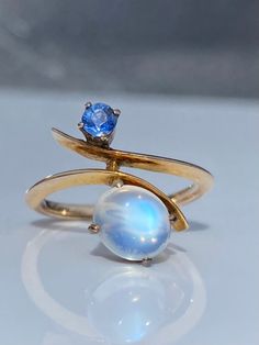 ~ Here we have a very beautiful early to mid 20th century moonstone and sapphire ring ~ The ring face measures approximately 17.9 north to south at widest point, sapphire 3.5mm, moonstone 7.85mm long ~ Unmarked, tests as 14ct gold  ~ In excellent condition, the stone is nice and secure, no chips or damage, the sapphire has an inclusion running through stone, visible under magnification which is not surface reaching, where it meets the girdle there is a very small natural cavity giving appearance Unique Yellow Gold Moonstone Ring, Hallmarked Yellow Gold Moonstone Ring, Unique Yellow Gold Moonstone Ring For Anniversary, Antique 14k Yellow Gold Moonstone Ring, Antique Oval Moonstone Ring, Victorian Round Moonstone Ring For Anniversary, Victorian 14k Gold Moonstone Ring For Anniversary, Antique Moonstone Ring For Anniversary, Vintage Moonstone Ring With Rose Cut Diamonds