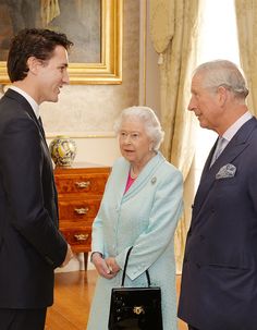 two men and a woman standing next to each other