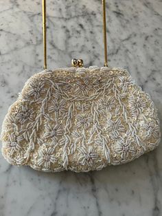 A fabulous white evening purse with heavy beading and sequins front and back. It has a gold tone chain handle which folds inside to make it a clutch purse.  Inside is silk lined with pockets and a sweet matching beaded wallet and a small mirror. The label says 'Mademoiselle handmade evening bag - Hong Kong' The perfect bridal or evening purse  In excellent condition  Measures  8.5" x 6" 11" drop with handle Beaded Wallet, Small Mirror, Sequin Wedding, Diy Purse, Evening Purse, Small Mirrors, Wedding Bag, Clutch Purse, Clutch Handbag