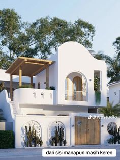 a large white house with plants on the balcony and balconies over the door