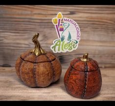 two small wooden pumpkins sitting next to each other