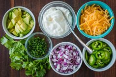 bowls filled with different types of food on top of a wooden table