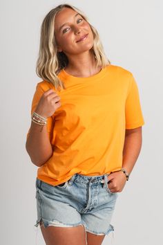 Basic short sleeve t-shirt from Lush Fashion Lounge women's boutique in Oklahoma City. Lush boutique in OKC has a variety of cute basic tops and more! This trendy basic t-shirt is a must have! Pair this basic orange top with shorts and sneakers for a cute and casual look! Model is 5'4 size 26 wearing size small. 100% cotton Casual Plain T-shirt For Spring, Trendy Plain T-shirt For Everyday, Trendy Short-sleeved T-shirt In Solid Color, Trendy Short Sleeve Crew Neck Top In Solid Color, Basic Solid Color Short Sleeve Tops, Basic Short Sleeve Solid Color Tops, Trendy Short Sleeve Solid Color Crew Neck Top, Trendy Short Sleeve Solid Color T-shirt, Spring Crew Neck Short Sleeve Top In Solid Color