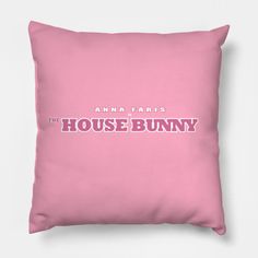 a pink pillow with the words,'the house bunny'printed in white on it