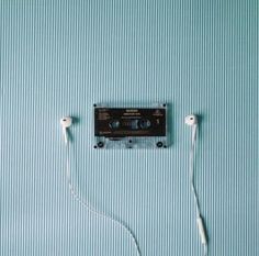 an old fashioned cassette player is plugged in to the wall with two white cords