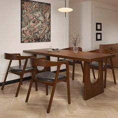 a dining room table with four chairs and a painting on the wall