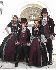 three people dressed in period costumes standing next to each other on a tile floor with an archway behind them