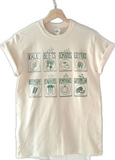 Organic Short Sleeve T-shirt For Spring, Organic Cotton Crew Neck Tops, Green Organic Relaxed Fit T-shirt, Organic White Graphic Print Tops, Organic Short Sleeve T-shirt With Screen Print, Relaxed Fit Shirt With Graphic Print For Gardening, Relaxed Fit Graphic Print Shirt For Gardening, Organic Green Short Sleeve Top, Organic Graphic Print T-shirt For Spring