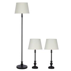 three lamps with white shades on them are sitting next to each other and one lamp is turned off