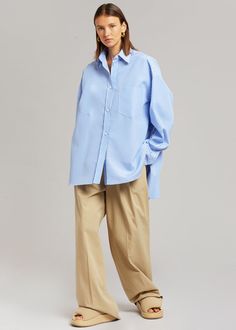 Color: White/Light Blue Lightweight shirting fabric Oversized fit Pointed collar Single breast pocket High-low curved hem Button front closure 100% Cotton Dry Clean By The Frankie Shop. Imported Product Measurements: XS/S - 24" Shoulder, 56" Bust, 31" Length M/L - 25" Shoulder, 59" Bust, 31.5" Length Model is 174cm/ 5'8" wearing size M/L Denim Projects, Shirting Fabric, The Frankie Shop, Frankie Shop, Top Design Fashion, Stripe Shirt, Work Wear Women, Cut Shirts, Striped Shirt