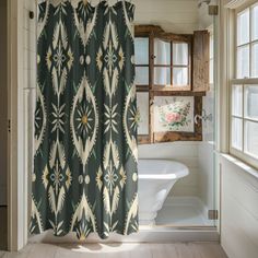 a bathroom with a shower curtain, toilet and tub in it's corner next to a window