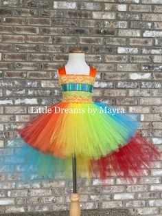 Welcome to Little Dreams by Mayra This dress is absolutely adorable and fun!, very puffy and colorful ! Skirt has four layers of tulle, candy ribbon and cute pom poms as showing on pictures, chest has an unique design with lace, ribbon, handmade lollipops and pom poms, this dress is a gorgeous piece, just perfect for your little one! It will fit just right for a birthday party, pictures or any occasion Matching hairpiece is included Crochet top 5''inches will be used for sizes nb to 2T Crochet t Multicolor Sleeveless Tutu Dress For Dress-up, Whimsical Rainbow Tulle Tutu Dress, Bippity Boppity Boutique, Birthday Party Pictures, Spring Princess Rainbow Tutu Dress, Candy Ribbon, Handmade Lollipops, Playful Rainbow Tutu Dress For Dress-up, Colorful Skirt