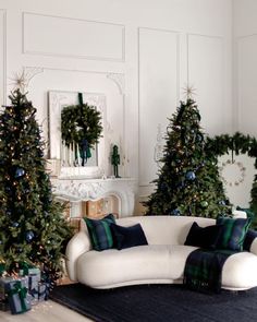 the living room is decorated for christmas with green and blue decorations, wreaths and garlands