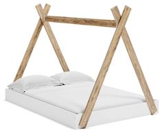 a bed with wooden posts and white sheets