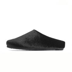 ‘The Pony Clog’ by ROAM is made from sleek faux calf hair and lined in ultra-soft and breathable cotton fleece that rests gently against the skin. Memory foam has been inserted by hand into the upper, making these extra comfortable, and allowing them to mold to your foot for a perfectly cushioned and supportive fit. RO Black Faux Fur Slippers For Winter, Comfortable Winter Clogs With Textured Sole, Modern Black Slippers With Textured Sole, Black Leather Winter Slippers, Black Faux Fur Slippers With Round Toe, Black Round Toe Mules For Winter, Winter Black Mules With Round Toe, Black Synthetic Clogs For Winter, Black Synthetic Slippers With Leather Sole